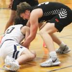 A hustling Henry Cartsen (20) dives on the floor to get a loose ball in a game against CK.