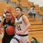 Everett Moore (21) drives to the basket on a fastbreak for the Spartans.