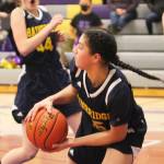 Ghadir Ramadan grabs the ball as teammate Maia Greiwe runs by in the NK game.