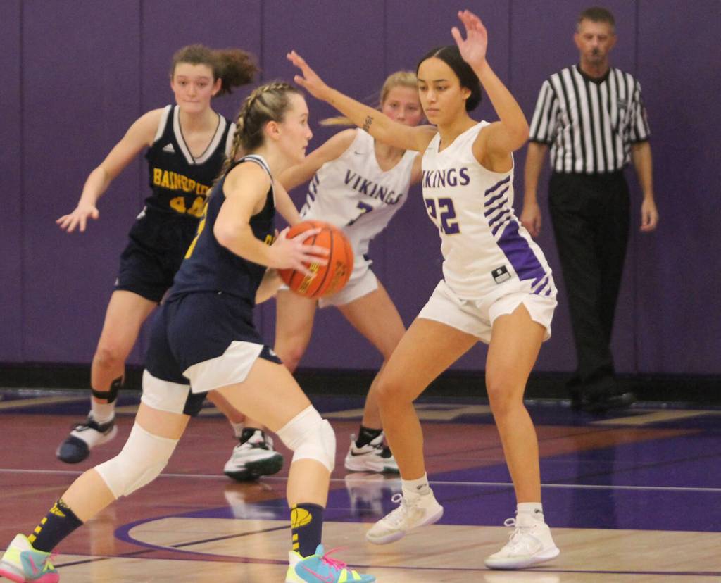 Grace Colburn (20) of Bainbridge drives to the hoop with Ayanna Selembo of NK defending.