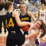 Sophia Baugh of North Kitsap struggles to take the ball away from Maia Greiwe of Bainbridge.