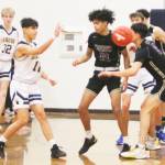 Spartan Breno Oguri (11) passes the ball in the North Kitsap game, while Harry Davies (12) defends and teammate Sam Nyland (32) looks on.