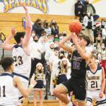 Cade Orness (10) drives to the hoop and puts up a short runner against James Carey (23) of Bainbridge. Breno Oguri (11) and Everett Moore (21) also defend. Steve Powell/Bainbridge Island Review photos