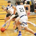 Jonas La Tour of North Kitsap reaches for the loose ball surrounded by Spartan players.