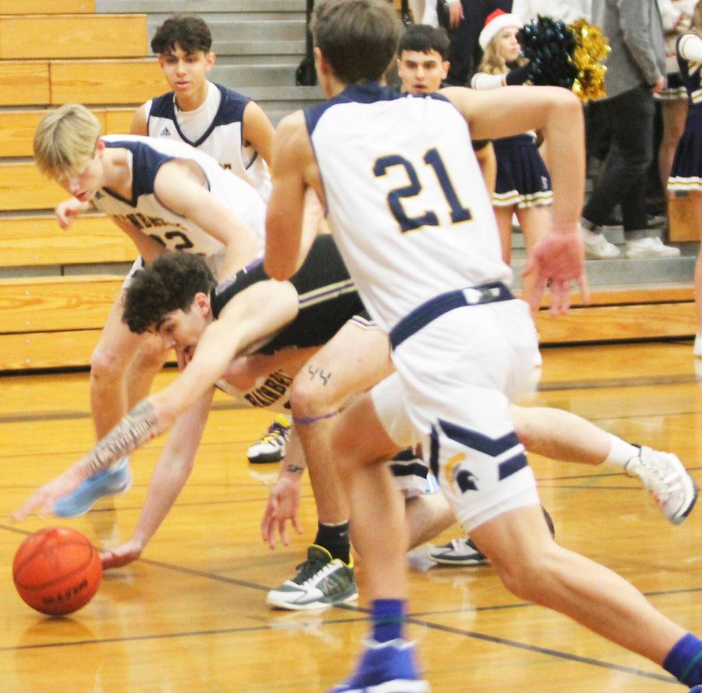 Jonas La Tour of North Kitsap reaches for the loose ball surrounded by Spartan players.