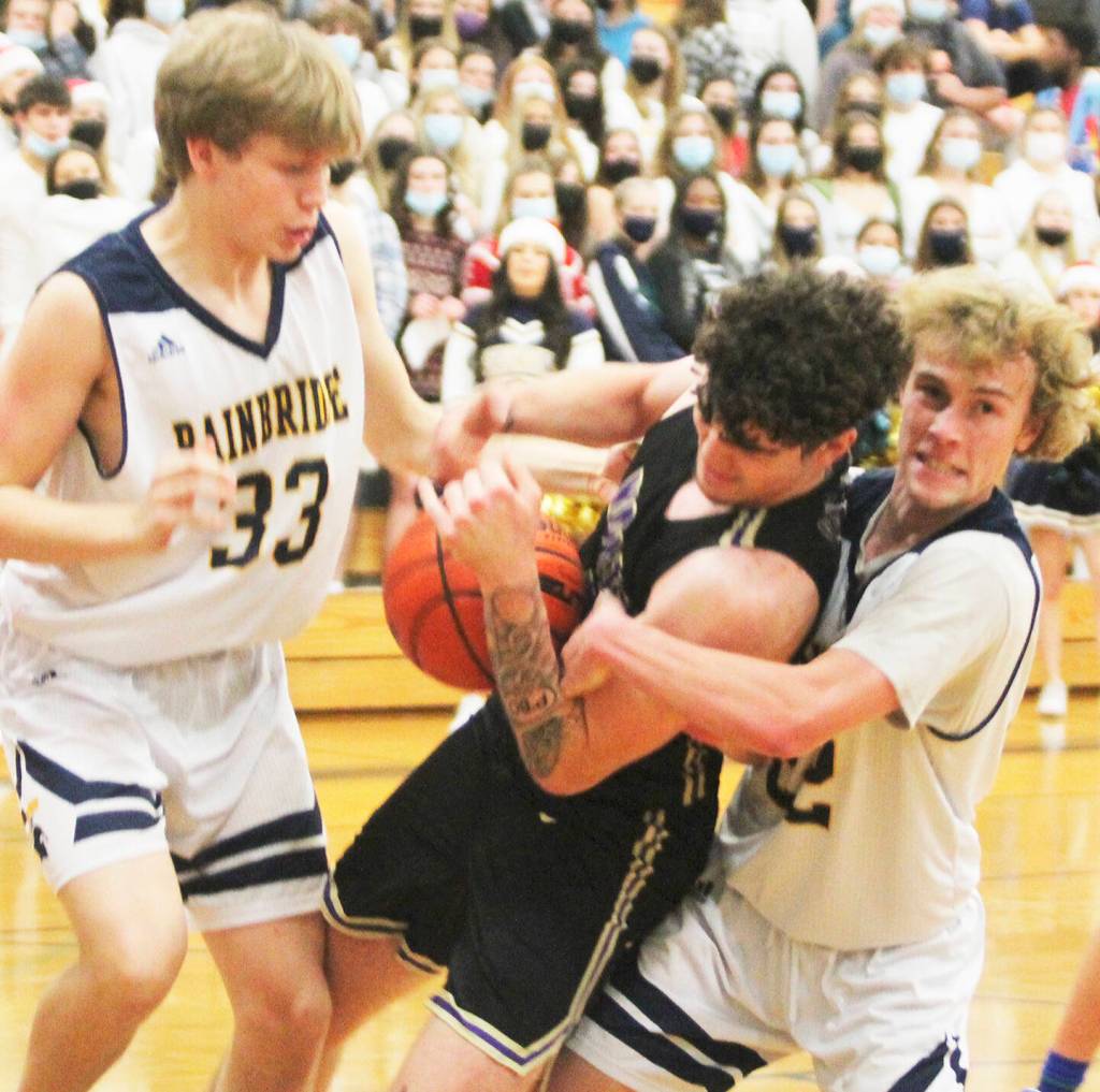 Braydon Morgan and Caleb Durrance (33) of BI tie up Jonas La Tour of North Kitsap.
