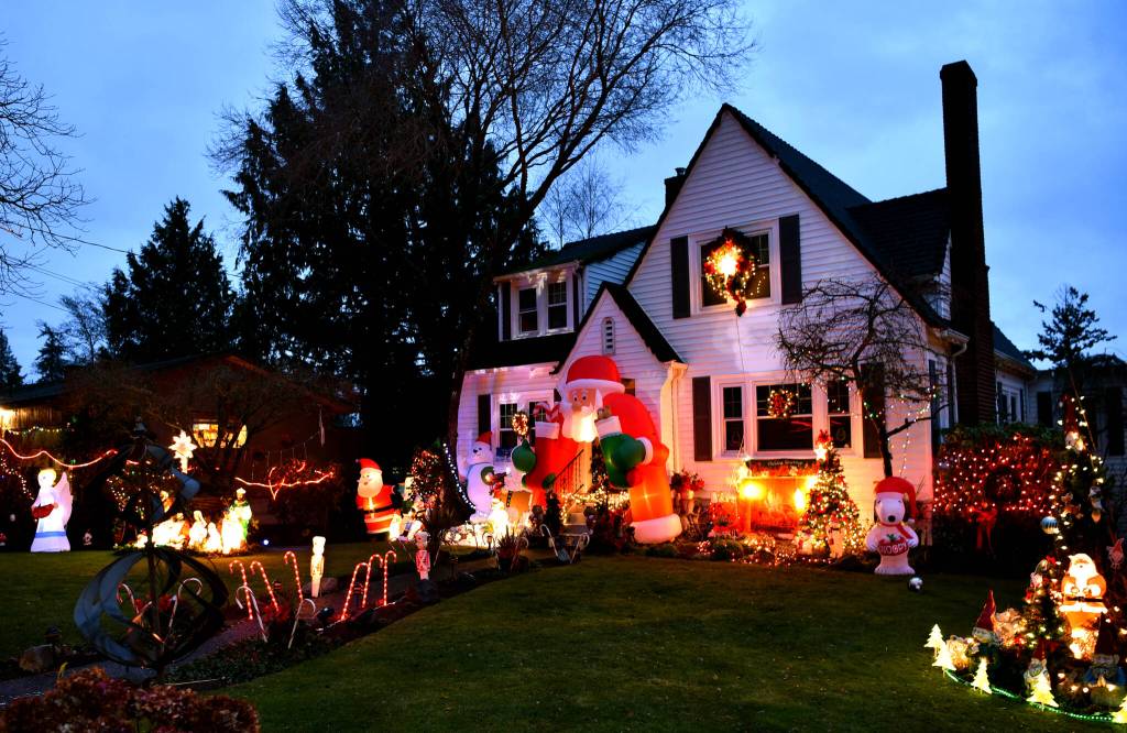 Christmas lights begin to glow as the evening darkens.