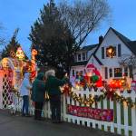 Jackie Callaham West, in green, shares her Christmas display with friends Mary Schoonmaker and Nancy Rekow at 296 Ferncliff Ave. NE. West has been adding to her holiday lights each season for 52 years. Nancy Treder/Bainbridge Island Review photos