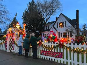 Jackie Callaham West, in green, shares her Christmas display with friends Mary Schoonmaker and Nancy Rekow at 296 Ferncliff Ave. NE. West has been adding to her holiday lights each season for 52 years. Nancy Treder/Bainbridge Island Review photos