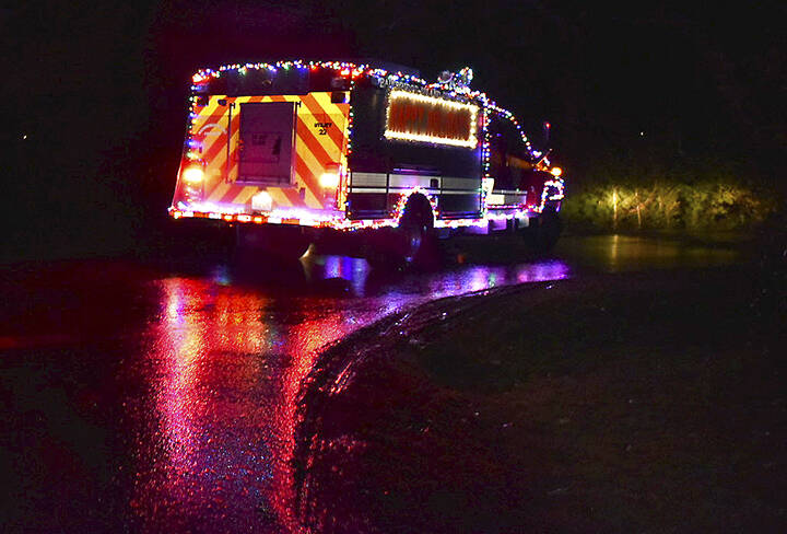 The Christmas firetruck makes its way around town.
