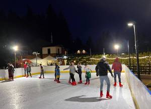 Skaters enjoy taking turns around the new ice skating rink featured at Pleasant Beach Village. The rink will be open to the public all winter. Nancy Treder/Bainbridge Island Review photos