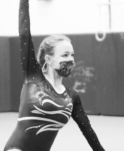 In gymnastics they wear masks while they compete, as Phare Deitrich does here in the floor exercise for Bainbridge. Steve Powell/Bainbridge Island Review
