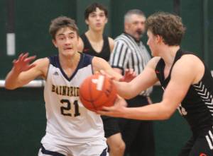 File photos
Everett Moore (21) of Bainbridge plays defense against North Kitsap.