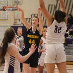 Maia Greiwe of Bainbridge (44) passes the ball between two North Kitsap defenders.