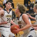 Braydon Morgan (with ball) makes an inside move to the basket while James Carey (23) blocks out for a potential rebound.