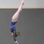 Avery Gray of Bainbridge, who won the all-around, goes vertical on the high bar against North Kitsap. Steve Powell/Bainbridge Review photos
