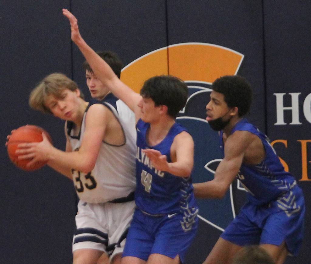 Caleb Durrance (33) of Bainbridge tries to get off a shot against tight defense. Steve Powell/File photos