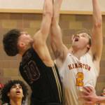 Buc Caden Krantz (2) goes up for a layup against North Kitsap's Cade Orness (10). The Kingston boys have a home playoff game Feb. 16. Steve Powell/File photo