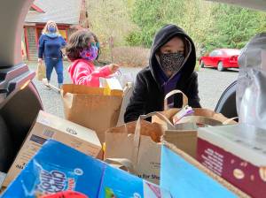 Courtesy photo
Island School third-graders on Bainbridge Island pack a vehicle with 637 grocery items from a school-wide drive for the Bremerton Backpack Brigade for 344 children who need supplemental food support every weekend.