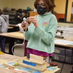 Fifth-grader Maggie Carson carefully makes one of her corkettes at the Maker Space where Sakai students create whatever they want.