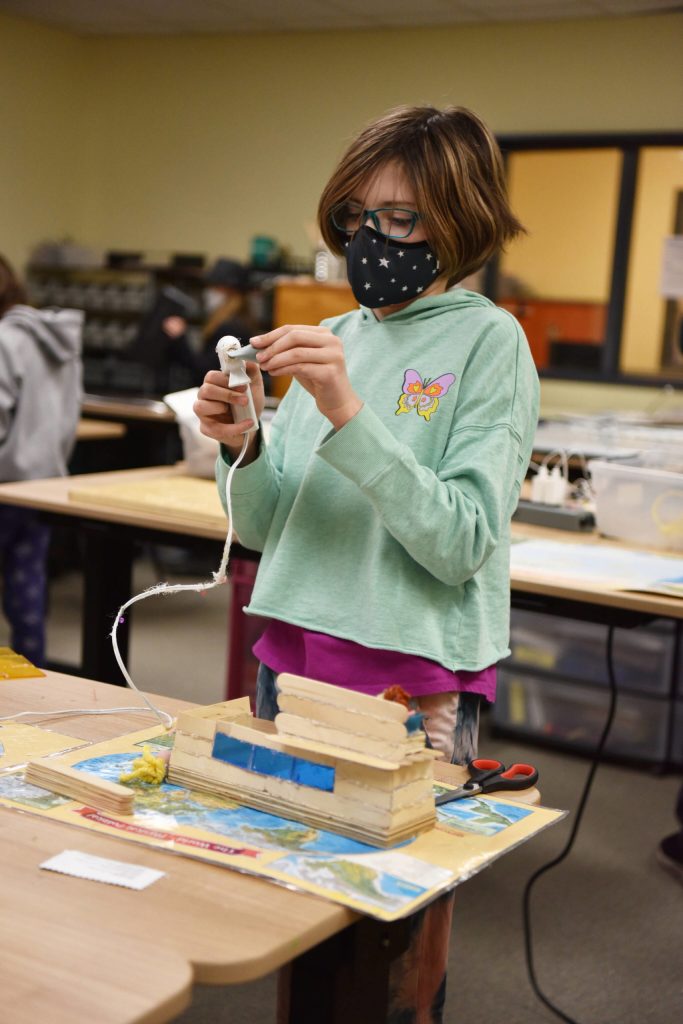 Fifth-grader Maggie Carson carefully makes one of her corkettes at the Maker Space where Sakai students create whatever they want.