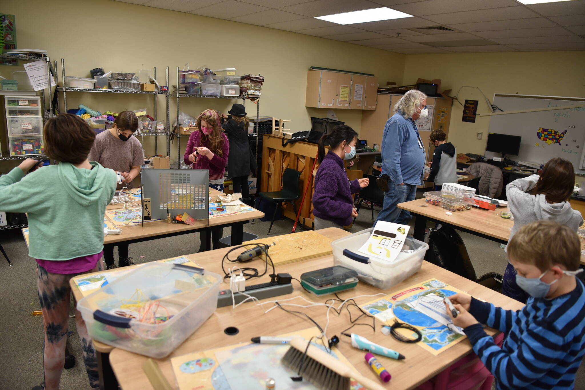 Fifth- and sixth-grade students make stuff from an array of supplies with encouragement from Mark Gurtler, who provides technology support at Sakai.