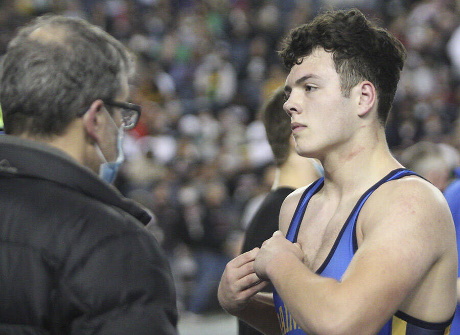 Wyatt Goade of Bainbridge listens to what happened in his second match.