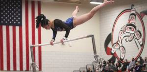 Freshman Jade Bereman of Bainbridge swings around the high bar at the state gymnastics meet last week.
Freshman Jade Bereman of Bainbridge swings around the high bar at the state gymnastics meet last week. Steve Powell/Bainbridge Island Review photos