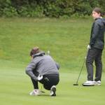 Hailey Fink and Myla Miller of Bainbridge watch as Kingstons Rebecca Smyth lines up a putt.