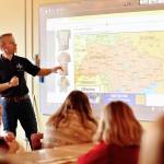 Nancy Treder/Bainbridge Island Review 
Above: Jake Gillanders showing students at St. Cecilia Catholic School the areas he visited on his recent trip to Poland and Ukraine as part of the humanitarian relief effort to help the refugees fleeing Ukraine.