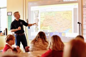 Nancy Treder/Bainbridge Island Review 
Above: Jake Gillanders showing students at St. Cecilia Catholic School the areas he visited on his recent trip to Poland and Ukraine as part of the humanitarian relief effort to help the refugees fleeing Ukraine.