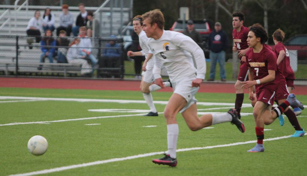 Calvin Moe (6), a senior midfielder, races past the Bucs heading toward the goal.