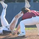 Junior Luke Lavigne of Bainbridge rolls over on his back after sliding safely into home plate in the 12-2 win over Kingston. Steve Powell/Bainbridge Review photos