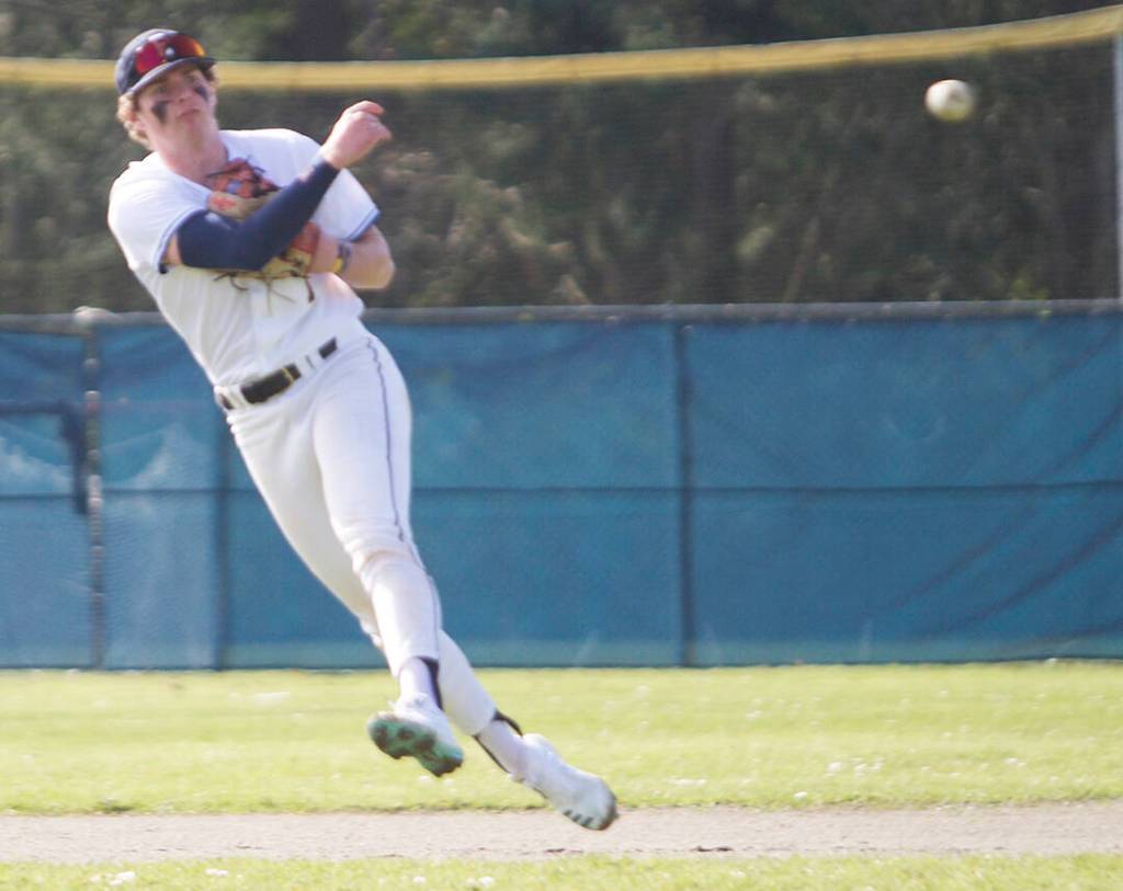 Senior shortstop JR Richie throws the ball to first base.