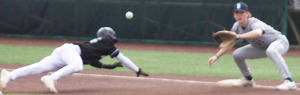 Owen Browning, the Spartan first baseman, looks like hes got this runner picked off easily, but the ball fell short and got by him.