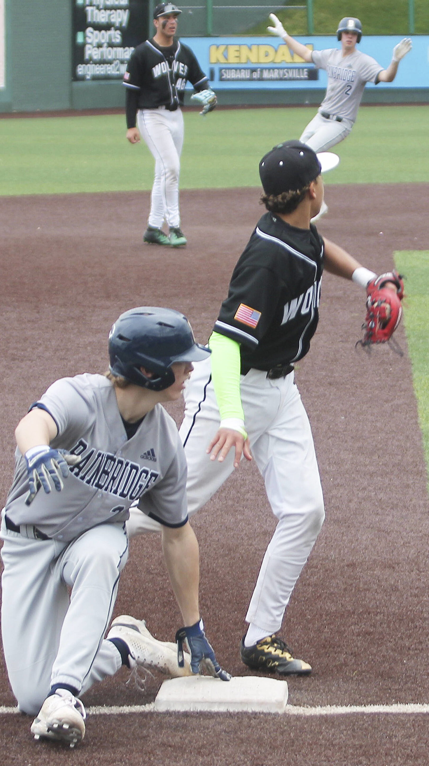Pulling off a double steal, Spartan Luke Lavigne (2) motions what he thinks the umpires call should be as Owen Browning (21) goes into third base. He was right, safe.