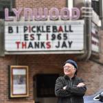 Kevin Lynch, general manager of the Lynwood Theater, waits for Gov. Jay Inslees motorcade to drive by his message on the marque.