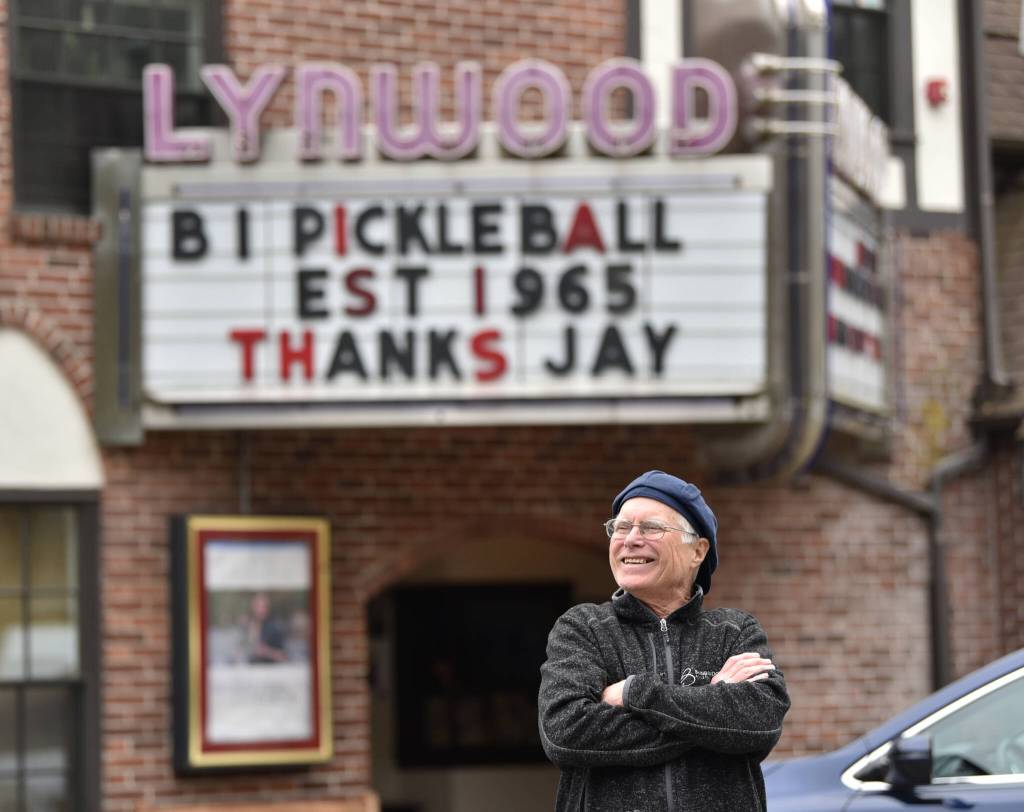 Kevin Lynch, general manager of the Lynwood Theater, waits for Gov. Jay Inslees motorcade to drive by his message on the marque.