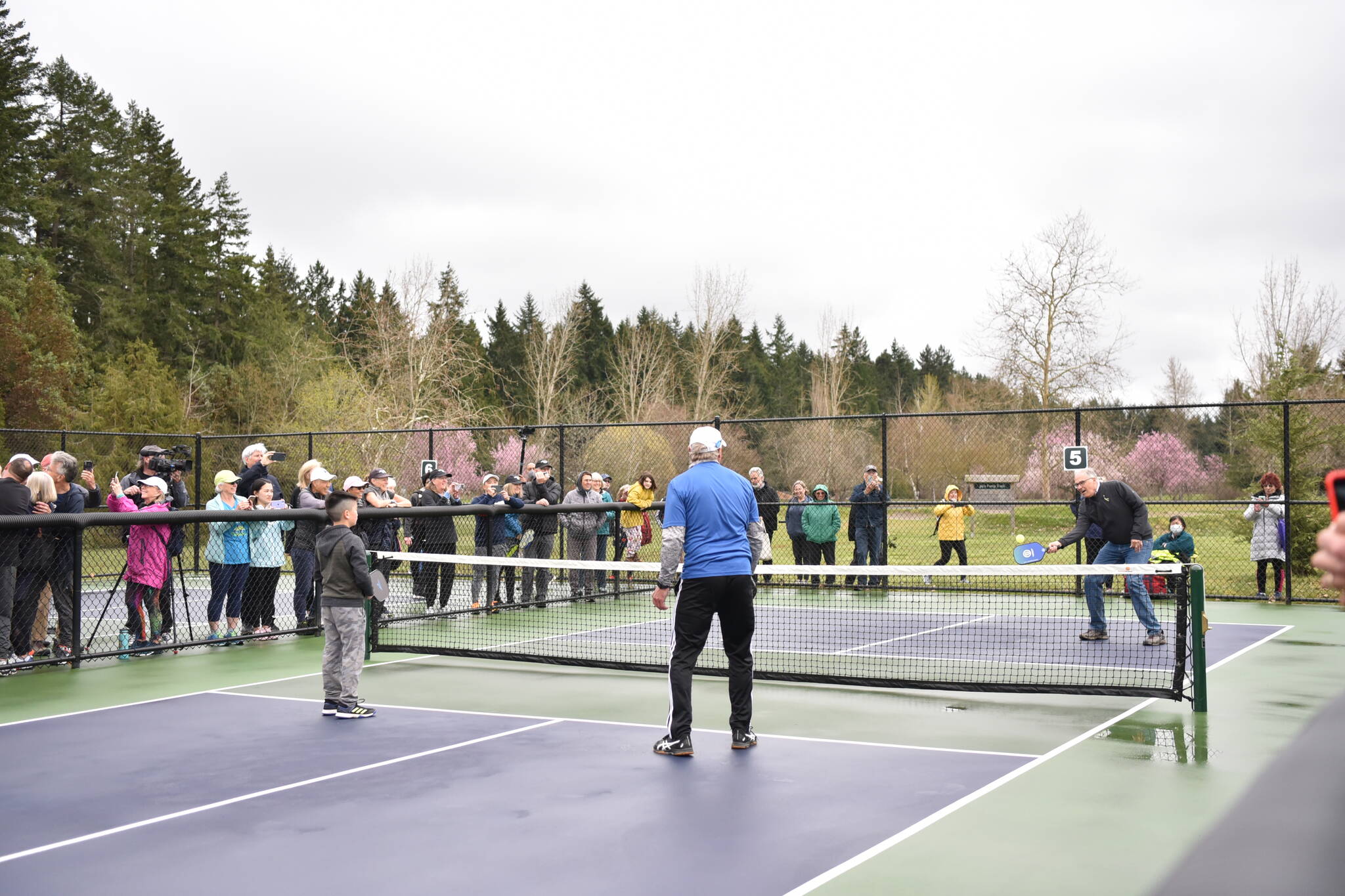 Gov. Jay Inslee participates in an exhibition pickleball game at Battle Point Park.