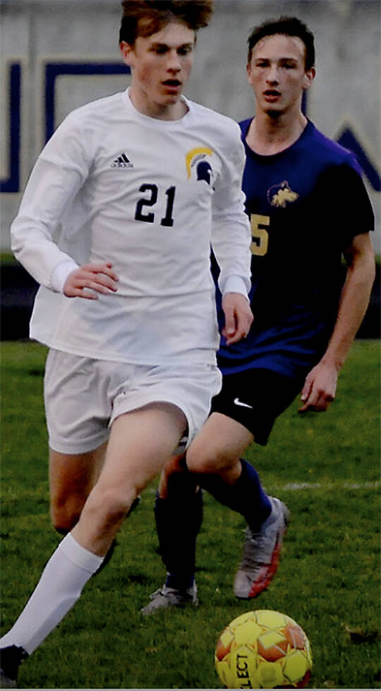 Sampson Murchie (21) of Bainbridge dribbles the ball up the field against Sequim. Michael Dashiell/Courtesy Photo