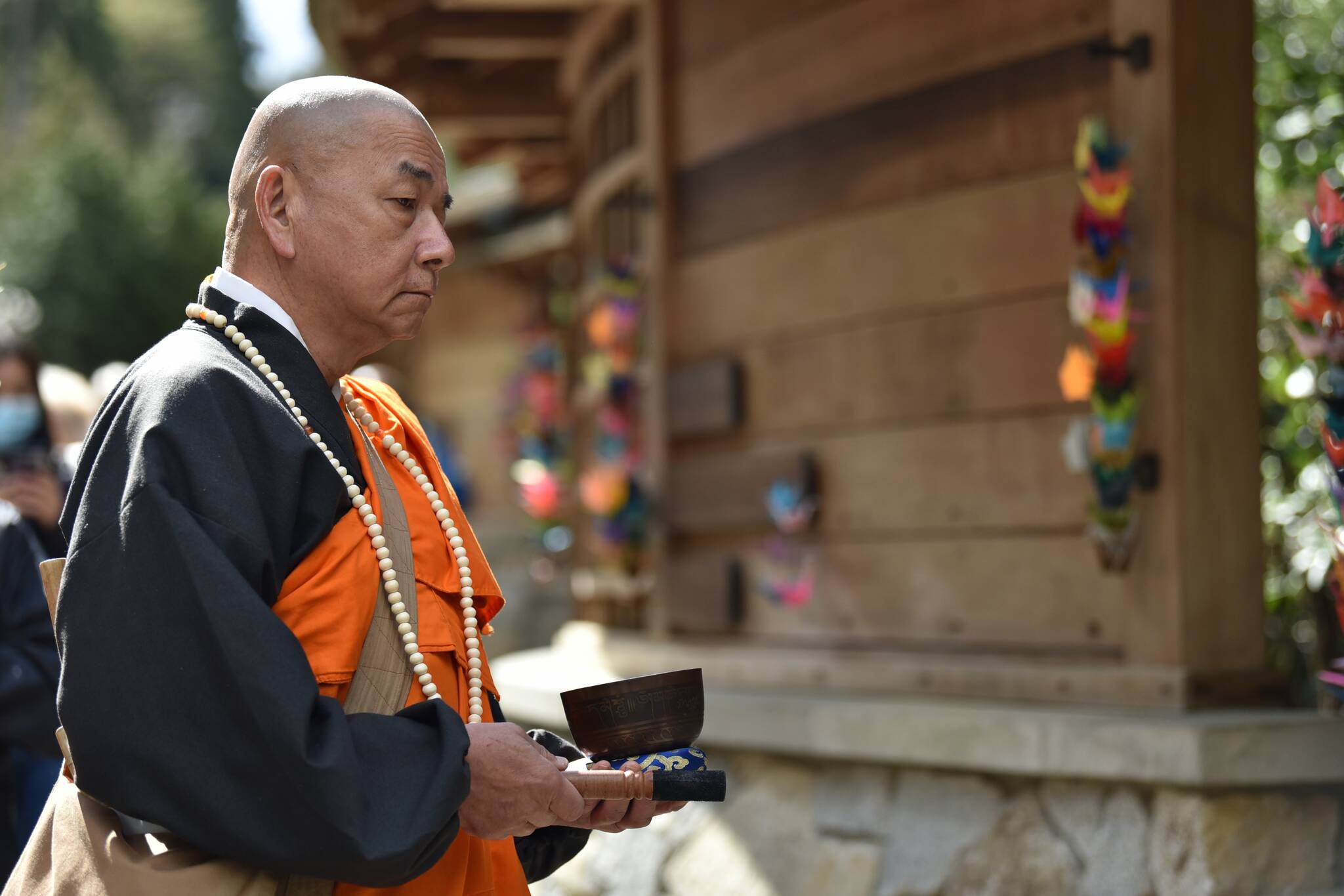 The Rev. Senji Kanaeda at Nipponzan Myohoji Bainbridge Island rang a gong during the reading of the names of the those forced from the island in 1942.
