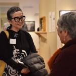 Artist Jan Hopkins speaks with a visitor at Americans Incarcerated: A Family’s Story of Social Injustice exhibit on display at BIMA through June 12.