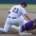 Colton Bower of NK dives safely back to first base after hitting a single in the first inning. Zach Duffy of BHS applies the tag. Steve Powell/North Kitsap Herald