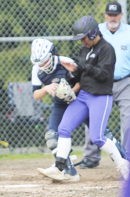 Bainbridge catcher Hayden Jobes tags out a Sequim runner just before she was to score.