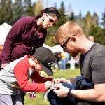 Amanda Brooke and Jordan Brooke look on as their son, Felix (5) writes down his findings for the plant scavenger hunt.