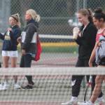 As Kingstons No. 1 doubles team of Kylie Sandstrom and Taliya Caldara cross the court, the Bainbridge team of Aya Gatto and Kristina talk with coach Mary McCombs. Steve Powell/Bainbridge Island Review photos