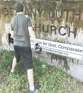 A Scout clean up the sign at Bethany Lutheran Church on Bainbridge Island. Courtesy Photo