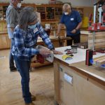 Dawn Weaver sands a cutting board in the woodworking studio.