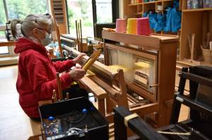 Catherine Camp works at a loom to weave a scarf in the Fiber Arts studio. Nancy Treder/Bainbridge Review photos