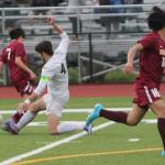 John Roman of Bainbridge does a slide tackle to take the ball away from an opponent earlier this year. Roman is a senior midfielder for the Spartans, who are seeded ninth for the state tournament. Steve Powell/File Photos